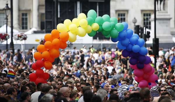 Pride march with rainbow balloon arch 
